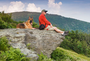 man hiking with dog