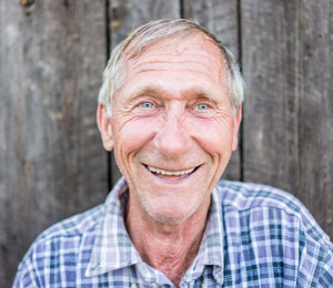 man in front of a barn